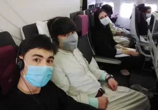 Members of the Afghanistan National Institute of Music on the plane to Doha. Courtesy of the Afghanistan National Institute of Music